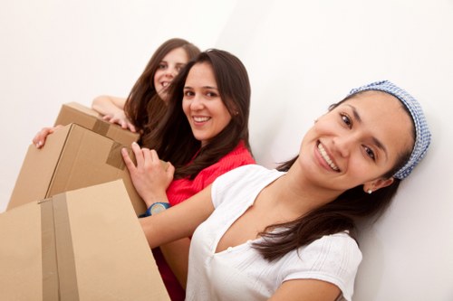 Team handling office furniture and equipment during a business relocation