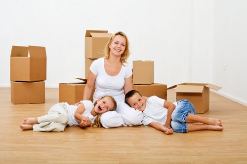 Moving boxes and furniture being loaded into a van